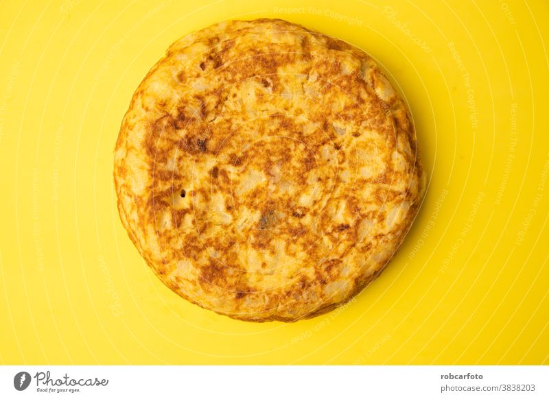 omelette with potatoes on yellow background wooden dish traditional mediterranean meal food tortilla tapas spanish espanola appetizer dinner cuisine olive egg