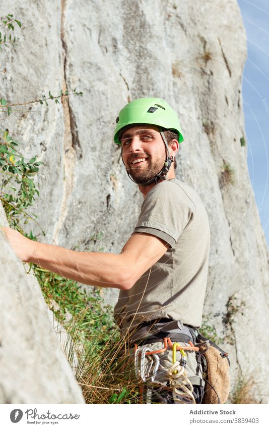Man in safety harness near rock climber man prepare extreme adventure equipment male carabine activity mountain forest belt active explore rope cliff challenge