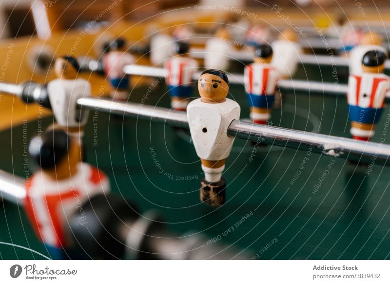 Vintage table football in room soccer game foosball retro vintage old fashioned player figurine nostalgia entertain tradition classic style wooden field green