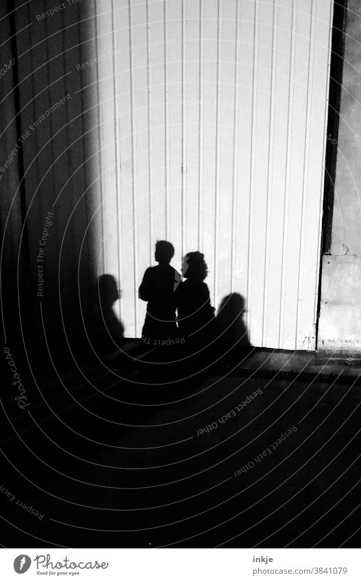 Shadows of several households Black & white photo Light Exterior shot group four individuals Drop shadow White Facade Wall (building) Gloomy Dark Bright