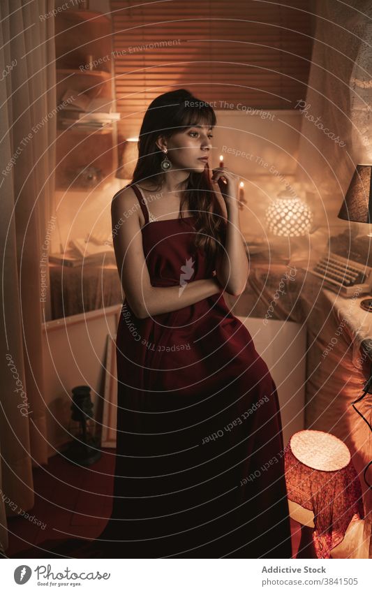 Young woman in cozy room at home atmosphere evening enjoy female old rest calm tranquil serene sit peaceful red dress young lady old fashioned nostalgia metal