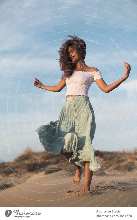 Serene woman walking on sandy beach at sunset carefree summer barefoot grace tranquil female outfit hill nature charming enjoy sundown freedom young smile