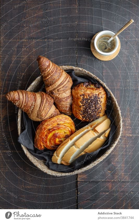 Various sweet bakery products in basket croissant bun roll homemade delicious wooden table food tasty baked bread meal yummy dessert pastry fresh tradition