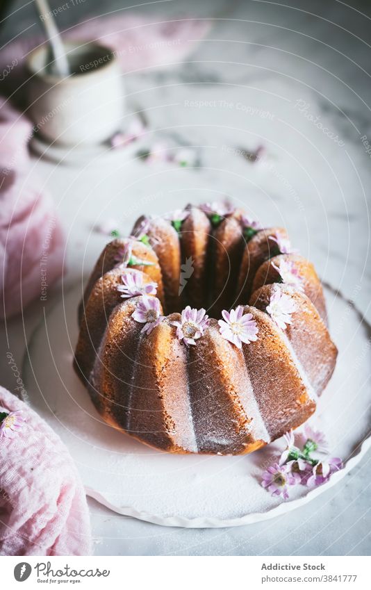Appetizing Bundt cake with flowers on table bundt cake tasty decoration serve dessert sweet delicious kitchen plate fresh gourmet yummy baked cuisine pastry