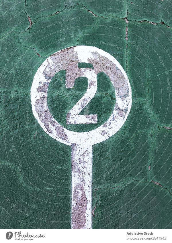 Shabby wall with painted number two winner leader concept shabby creative 2 victory goal symbol green color sign surface weathered old grunge success achieve