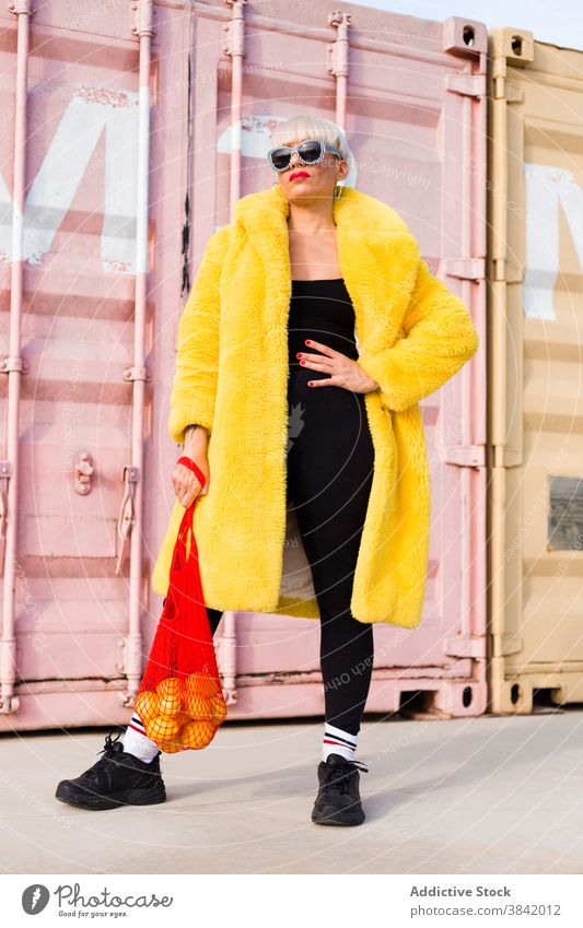 Stylish woman in vivid clothes on street hipster outfit stand bright sack eco friendly orange vibrant female color city style modern cool fashion young vogue