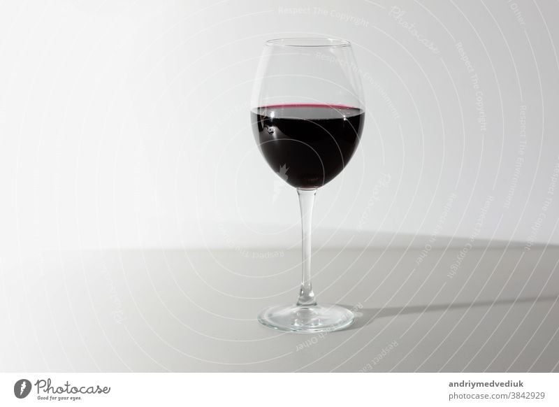 Glass of red wine isolated on white background. A glass of red wine. Copy space. drink alcohol celebration wineglass merlot cabernet splash abstract closeup