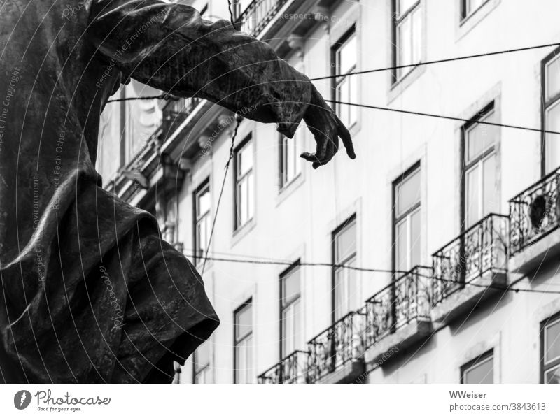 Dramatic gesture of a statue in the middle of Lisbon Statue Hand Facade houses Interpret Fingers Swing Elated Indicate Edge crease Cable Tram Largo do Chiado