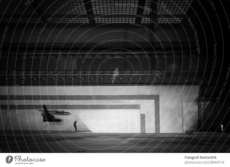Nocturnal station (Leipzig underground station), a single man pushes his bicycle Abstract architectonically Architecture Bicycle Black black on white Building