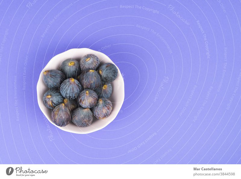 Bowl with figs on a blue background. Copy space. cut bowl fruit copy space ripe food healthy delicious top view tasty sweet dessert homemade harvest ingredient