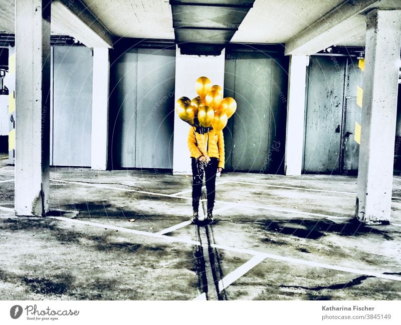Gold Balloons Yellow balloons Colour photo Underground garage Gray White Black yellow jacket black pants Line Parking garage Art Stand creatively Creation