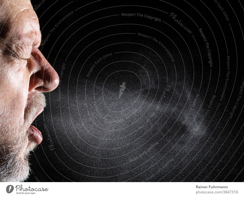 A man sprays aerosols into the air as he speaks. Air airborne attention background Bacterium Beard Black Corona coronavirus covid-19 Detail Illness