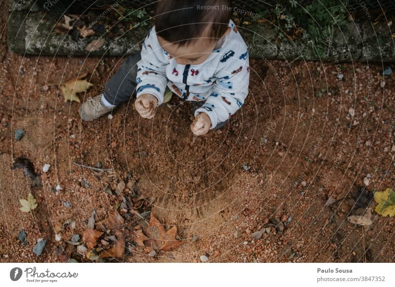 Toddler playing with sand at the park Authentic Sand flooring Child Children's game childhood Nature Curiosity Happiness Human being Leisure and hobbies