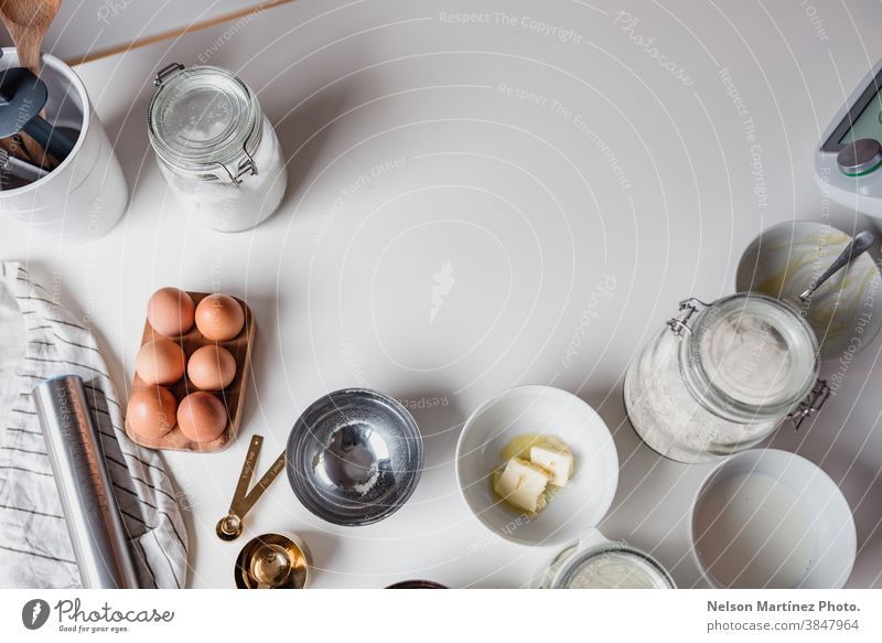 White table with ingredients for bakery. Eggs desserts butter salt flour food cooking home home made healthy copy space containers business cafeteria restaurant