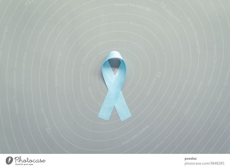 November light blue ribbon on gray background with copy space, Prostate cancer awareness month, men's health concept Sexual achalasia award blue november care