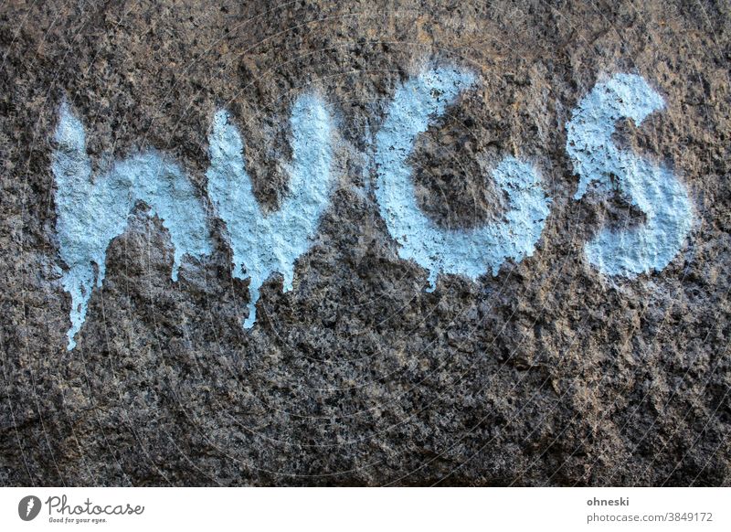 Graffiti "hugs" on a wall Typography Day light blue Blue Stone