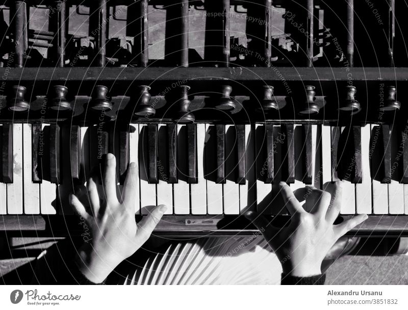 Two hands playing an old piano. Piano Old Black & white photo Girl instrument clasic