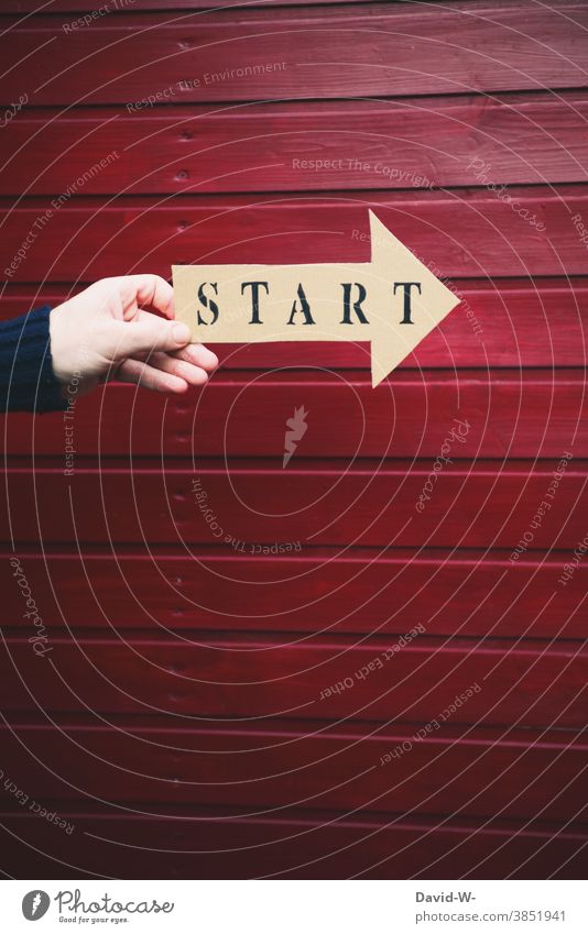 Start printed on an arrow is held by one hand launch Arrow Hand Beginning loose start Sign Direction Success Forwards Career