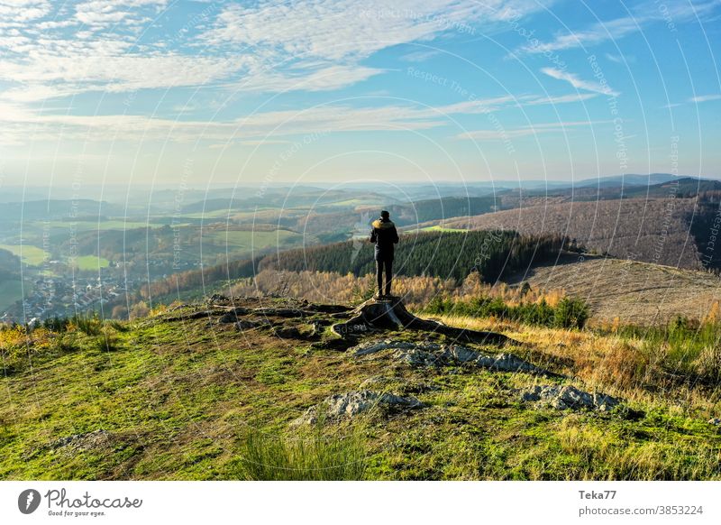 a man standing in the winter on a hill in nature overlook man in the nature green orange hills hiker hiking outlook