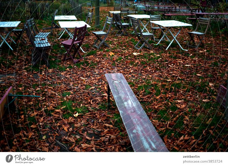 Beer garden in November Bench corona Gastronomy Closed Autumn Autumn leaves Folding chair Folding table Crisis Foliage colouring melancholy October broke rist