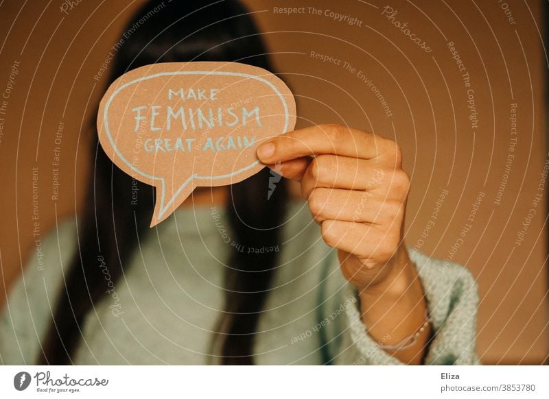 Woman holding a speech bubble that says "Make feminism great again". Feminism, emancipation, equality. Emancipation equal rights Speech bubble Equality Society