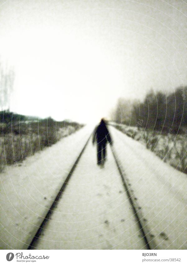 the aisle into the light Loneliness Cold Railroad tracks Human being Snow railway embankment Shadow
