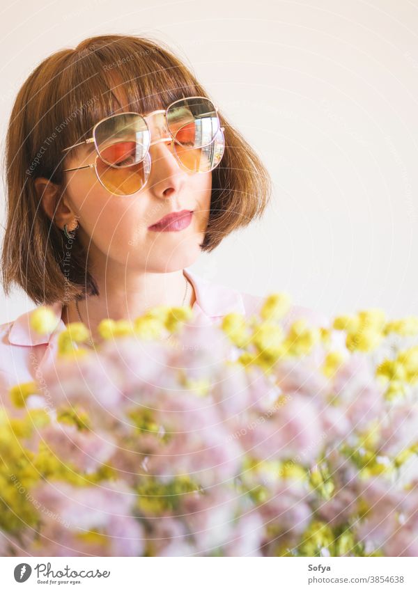 Young woman in pink shirt with sunglasses young fashion accessory autumn spring flowers transparent retro vintage girl brunette face smile fun funny lady wear