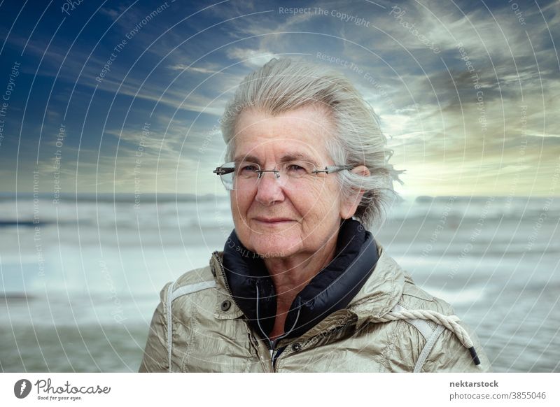 Elderly Caucasian Woman Portrait on Picturesque Sky Background woman caucasian senior portrait elderly real life real people outdoor beach sincerity kindness