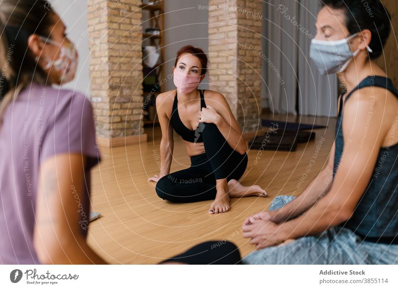 People in masks talking in yoga studio man women break lesson group pandemic speak together discuss conversation epidemic covid19 covid 19 coronavirus