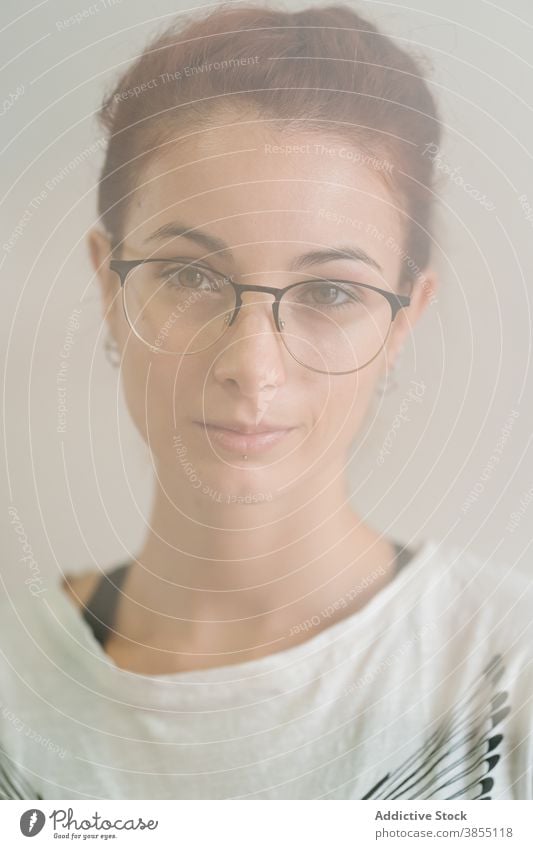 Smart woman looking at camera appearance smirk smart young portrait glasses casual confident individuality female clever eyewear modern model accessory