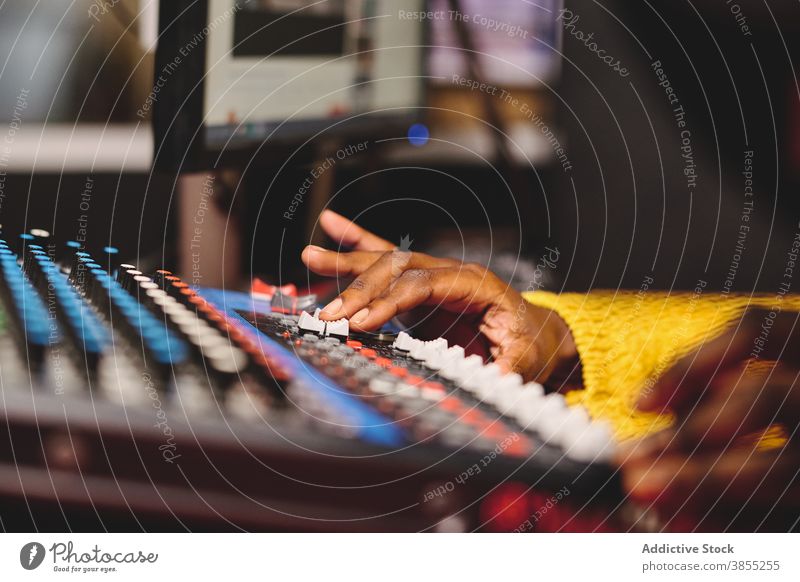 Crop black woman using control panel at radio station mix console broadcast host microphone on air radiocast female ethnic african american audio mixer live