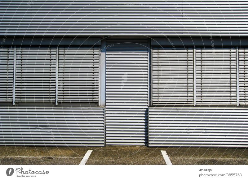 Sealed off and mothballed Closed Metal Building lines Facade Architecture Roller shutter Gray lockdown Economic crisis