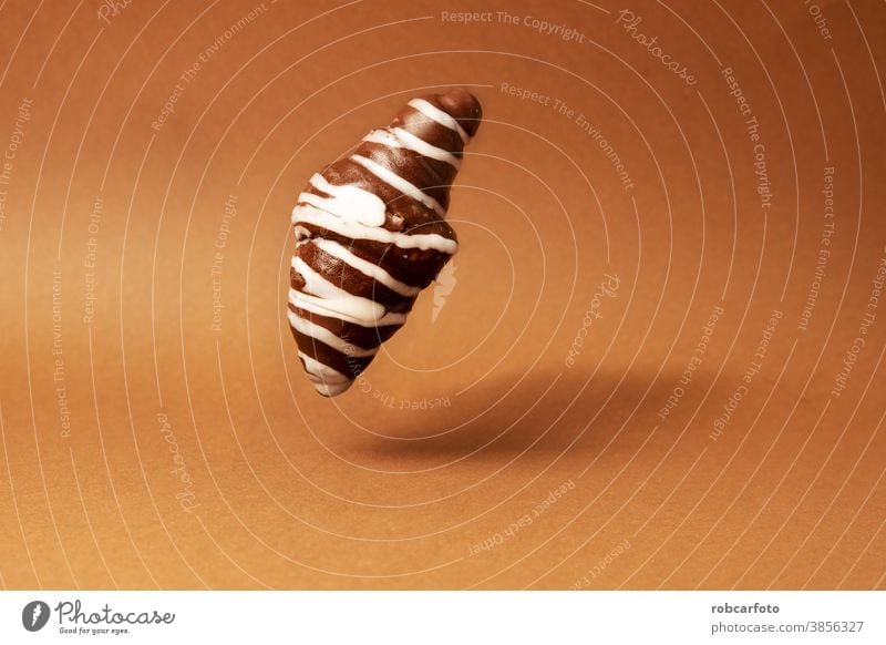 chocolate croissant on brown background sweet fresh tasty bun bake closeup dessert pastry crust food delicious bakery bread french nobody gourmet breakfast meal