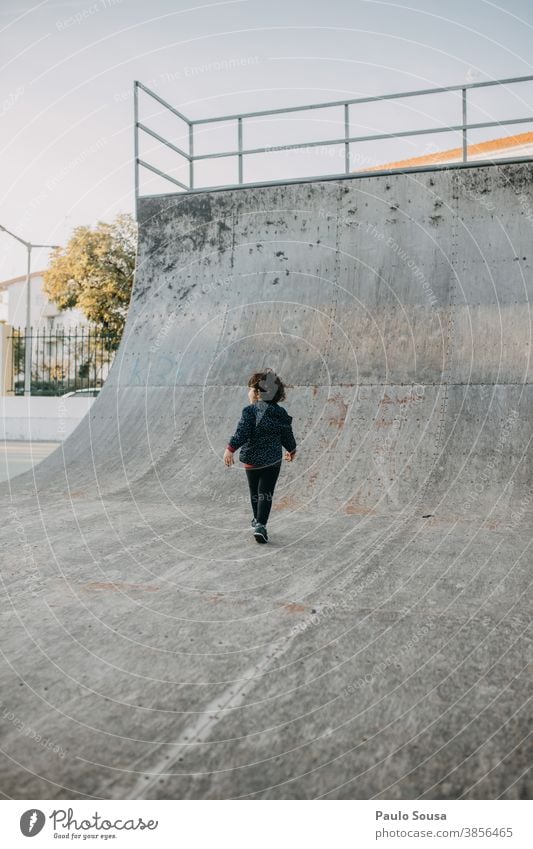 Rear view child playing at skate park Skateboarding Skate park Halfpipe Child childhood Children's game Park Autumn Authentic copyspace Copy Space Infancy