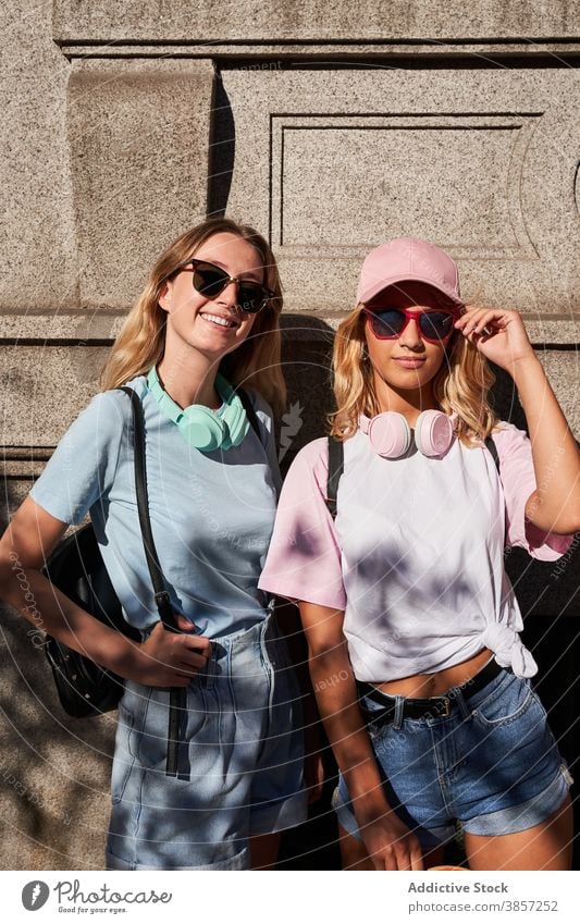 Trendy young women with standing in city friend urban blonde trendy together happy teenage cheerful girl sunglasses girlfriend headphones cool millennial