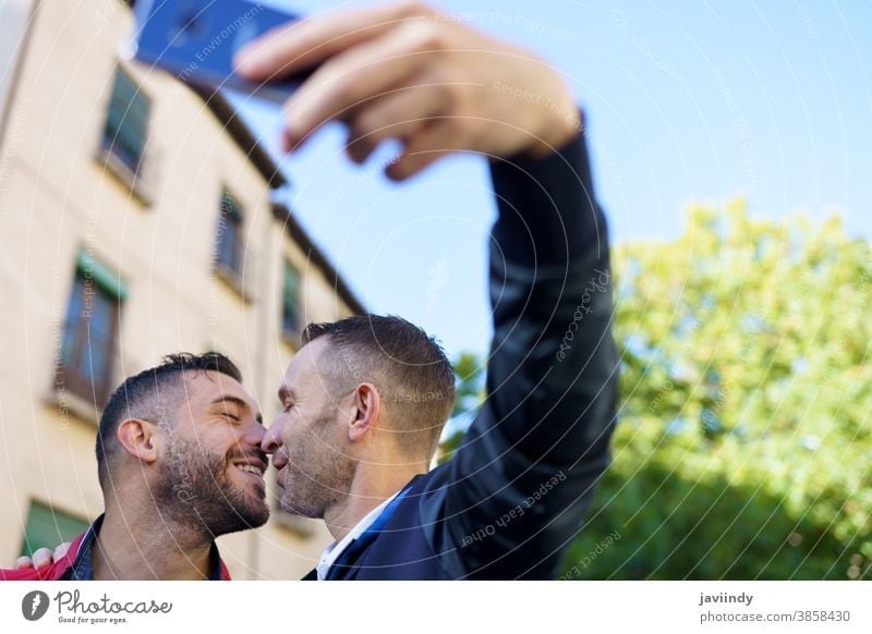 Gay couple making a selfie with their smartphone. gay men kiss kissing male love homosexual lgbt lgbtq relationship lovers albaicin granada boyfriend people