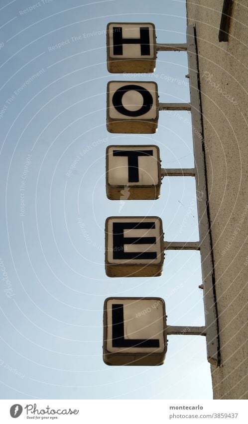 Illuminated advertising "Hotel" in front of a blue sky White Blue lettering Letters (alphabet) Quarter accommodate Check in rent Large Tall Sky Tourists