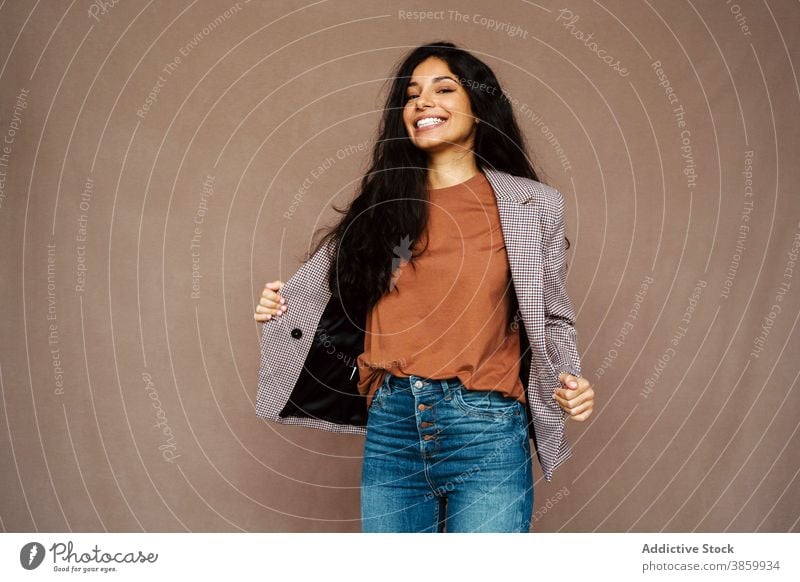 Cheerful woman in stylish wear in studio style jacket trendy laugh cheerful having fun model charming female ethnic happy young pleasure relax optimist modern