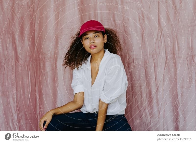 Young ethnic woman in trendy outfit style fashion cap confident afro casual cloth millennial female african american black headwear young individuality brunette