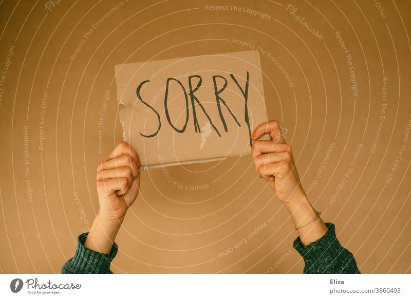 Person holds a sign that says Sorry. Sorry. sorry Apology hands apologize Text Error make mistakes Remorse Regret message concept person Misconduct Moral