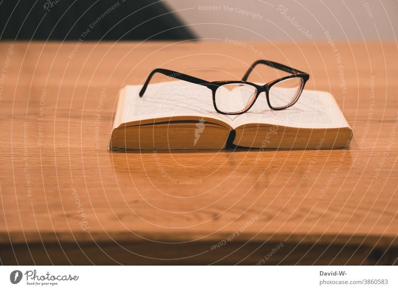 Book and glasses are on a table Break time-out Eyeglasses Reading Study Academic studies School tranquillity Leisure and hobbies