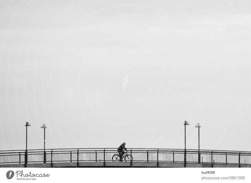 Cycling on a bridge - the lanterns frame the event artistically Bicycle Human being minimalism Lifestyle Adults Silhouette Movement Cycling tour Sports Wheel