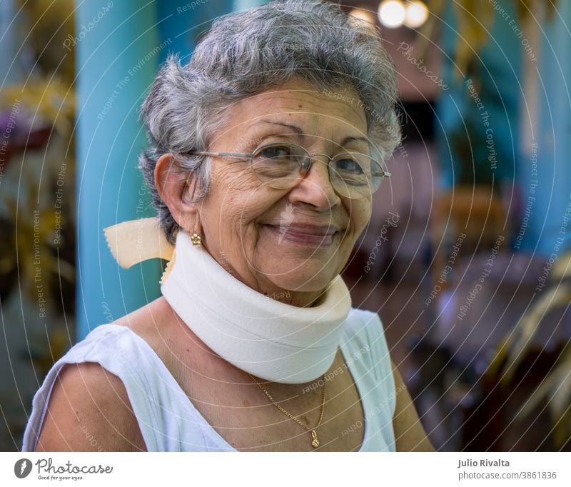 Homemade cervical collar healthcare glasses therapy cervical injury patient portrait pensioner retired elderly neck wrinkled eyeglasses female grandmother woman