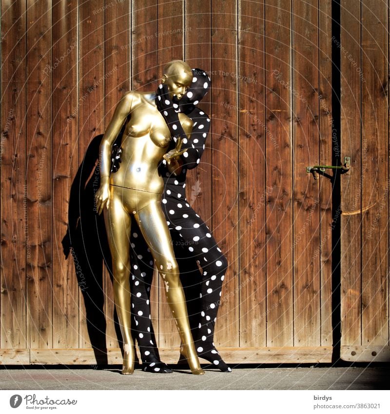 Man in a morphsuite costume tenderly embraces a golden naked mannequin relation Love Couple Sexuality gender Androgynous Mannequin Anonymous Naked Woman