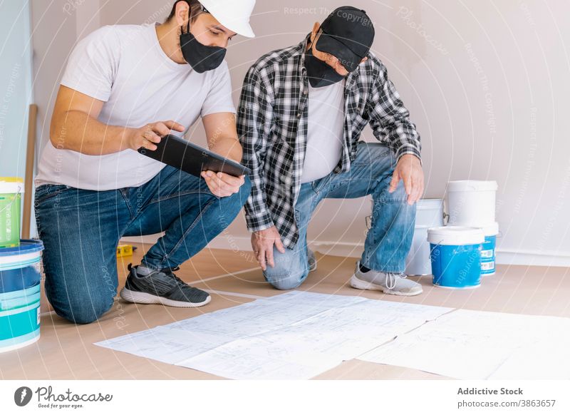 Male workers preparing for painting in room renovate flat painter prepare men together renewal draft sketch apartment occupation job professional protect