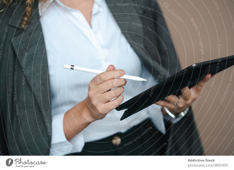 Focused businesswoman using tablet in studio project success close up entrepreneur anonymous focused achieve female formal work job outfit occupation internet