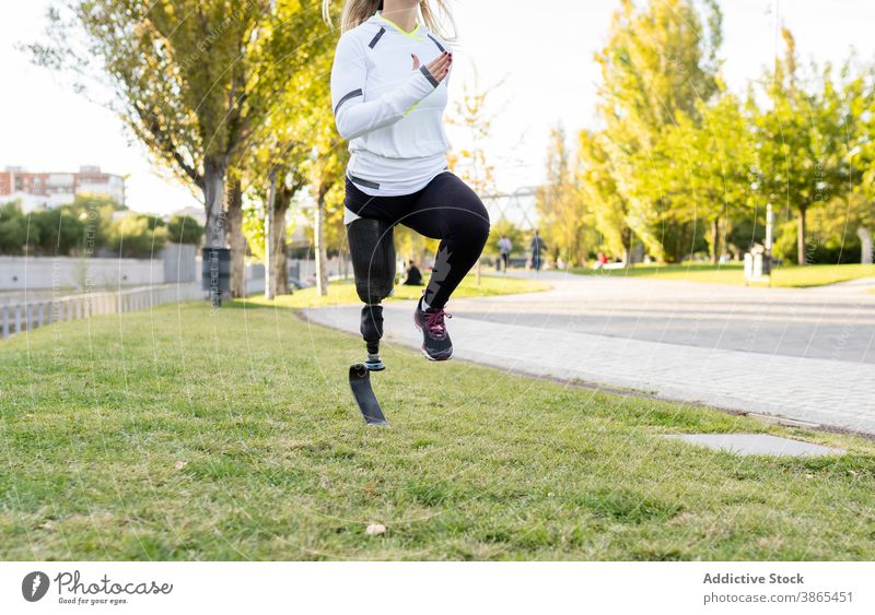 Crop runner with leg prosthesis practicing during workout paralympic woman bionic sportswoman artificial limb training exercise female practice energy