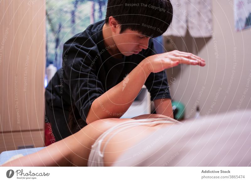 Masseur putting cubit on client while doing rehabilitation massage in professional salon masseur patient treat care therapy procedure wellness healthy wellbeing