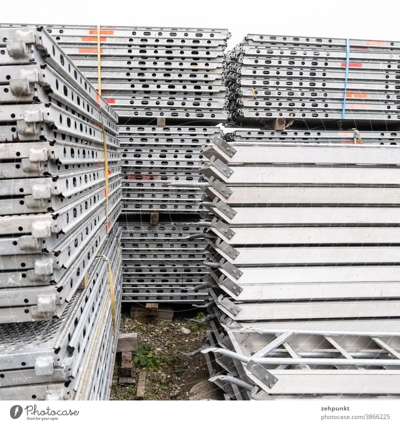 Several stacks of scaffolding parts Stack Building materials Repeating Storage area Gray Scaffold