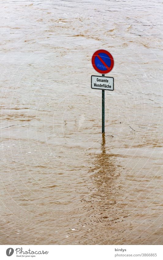 Flooded road after high water, only a road sign is looking out of the floods Deluge Climate change River cataclysm Global warming flooded Water street sign